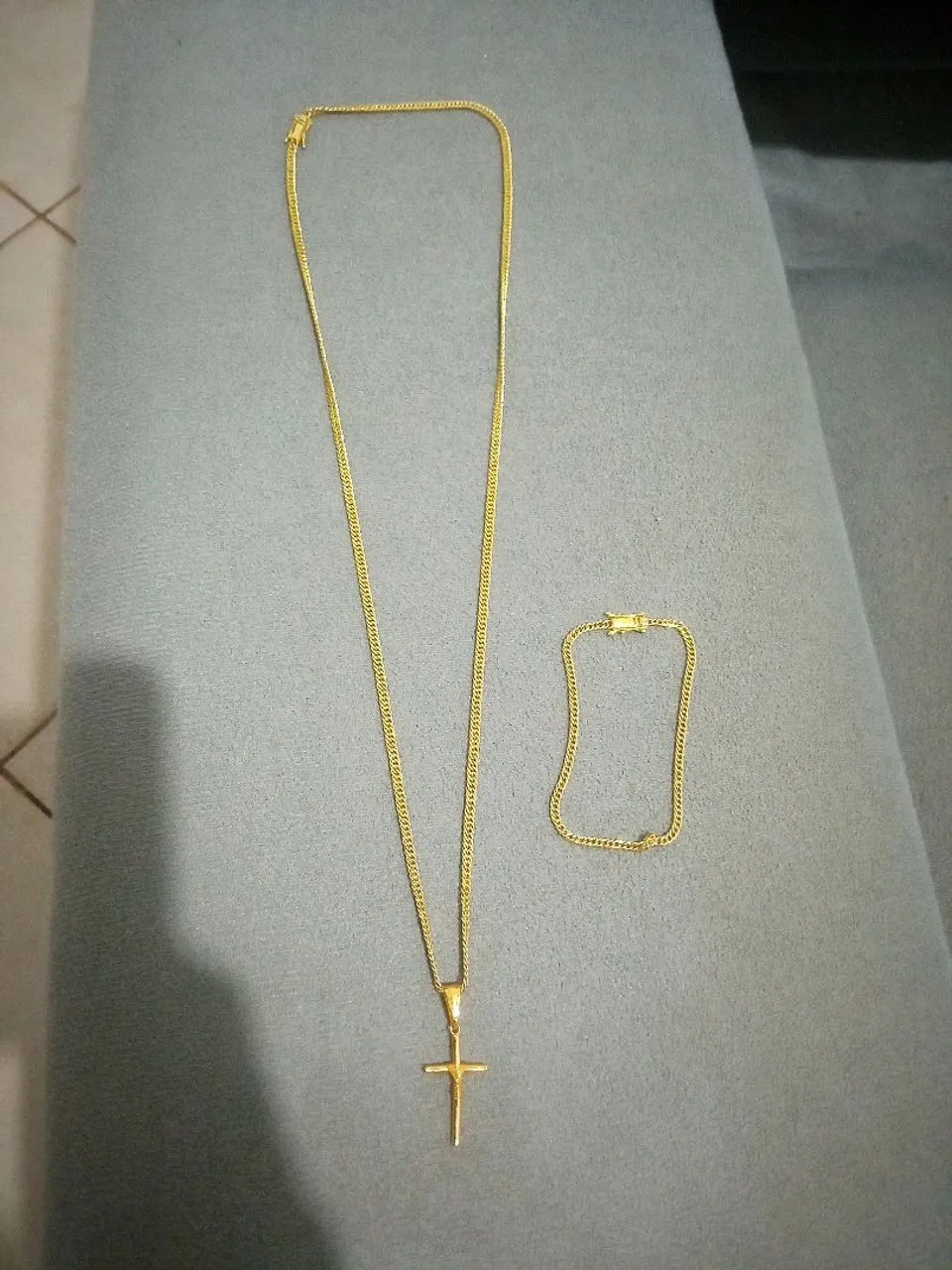 Conjunto de colar e pulseira dourados com cruz