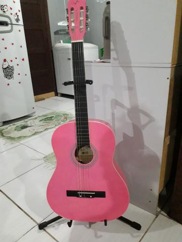 Vendo violão em ótimo estado praticamente novo ,a companha um suporte pra por o violão