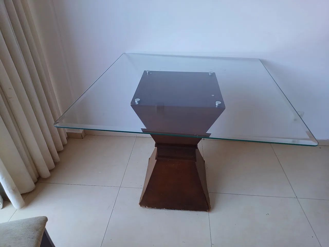 Mesa de vidro com base em madeira
