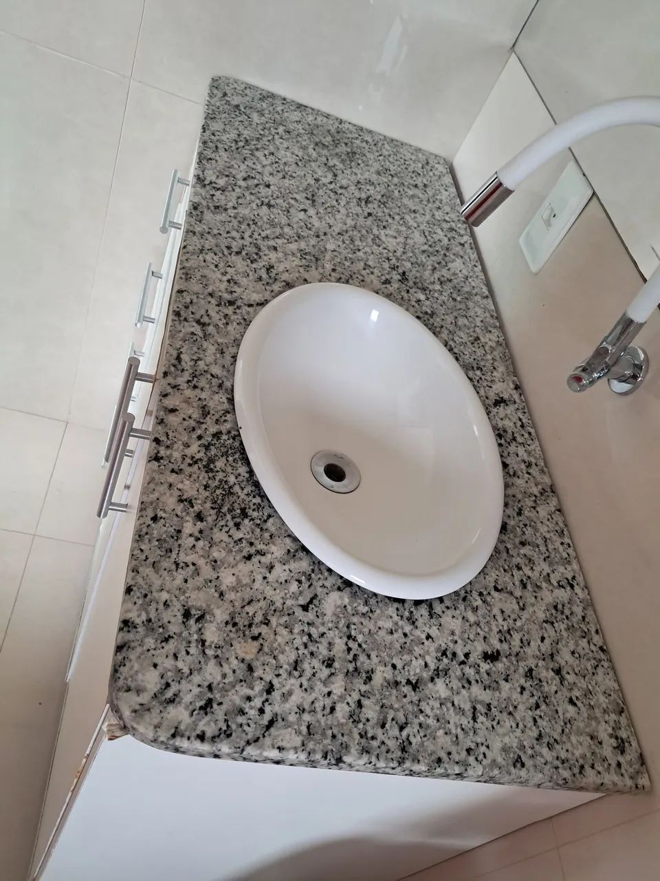 Used granite bathroom sink with an above-counter oval white basin, positioned on the right without cabinet.64728842655619120