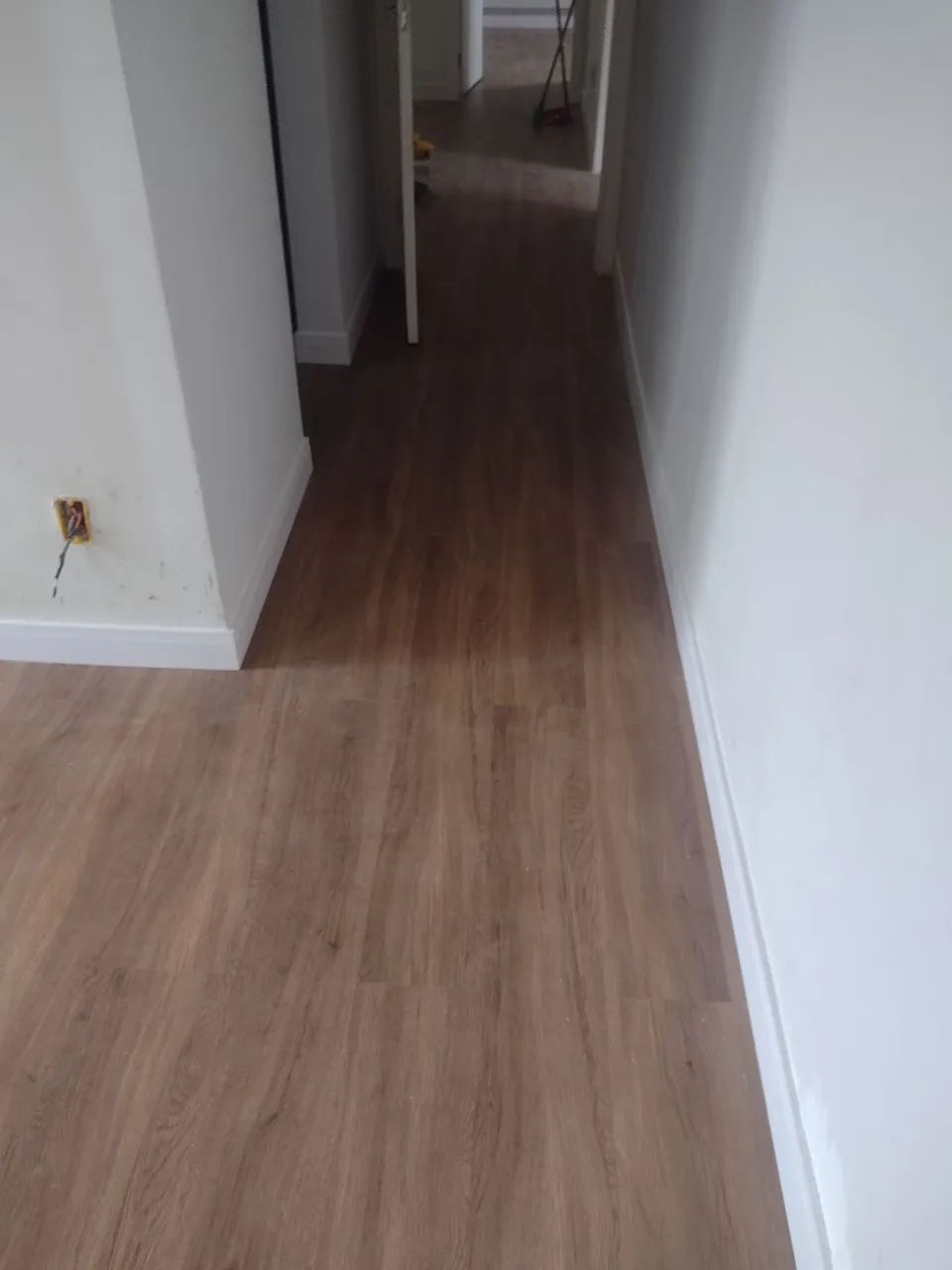 Installation of laminate flooring and baseboards and vinyl flooring
