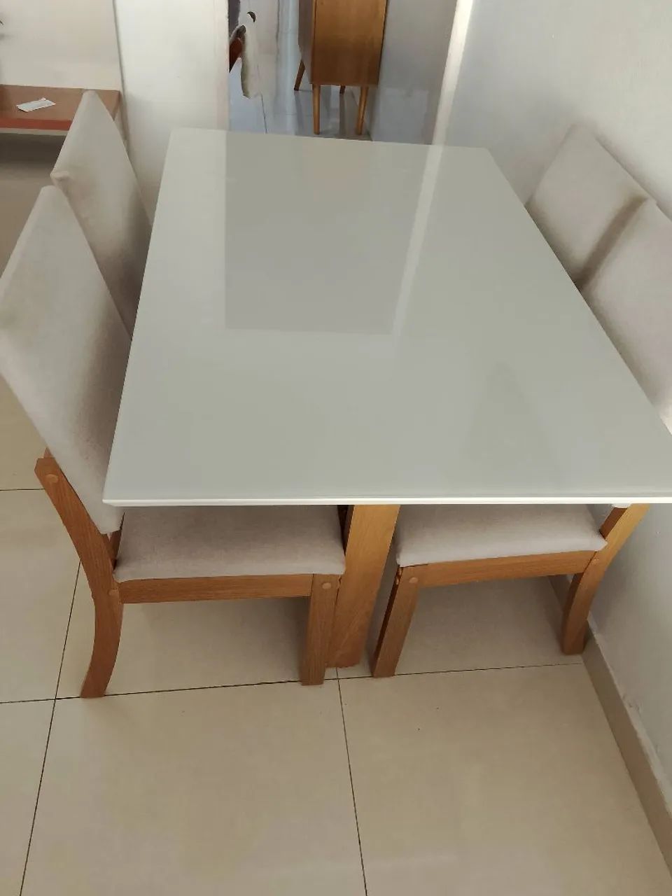 mesa madeira em MDF com 4 cadeiras estofadas  e tampo de vidro na cor off-white 