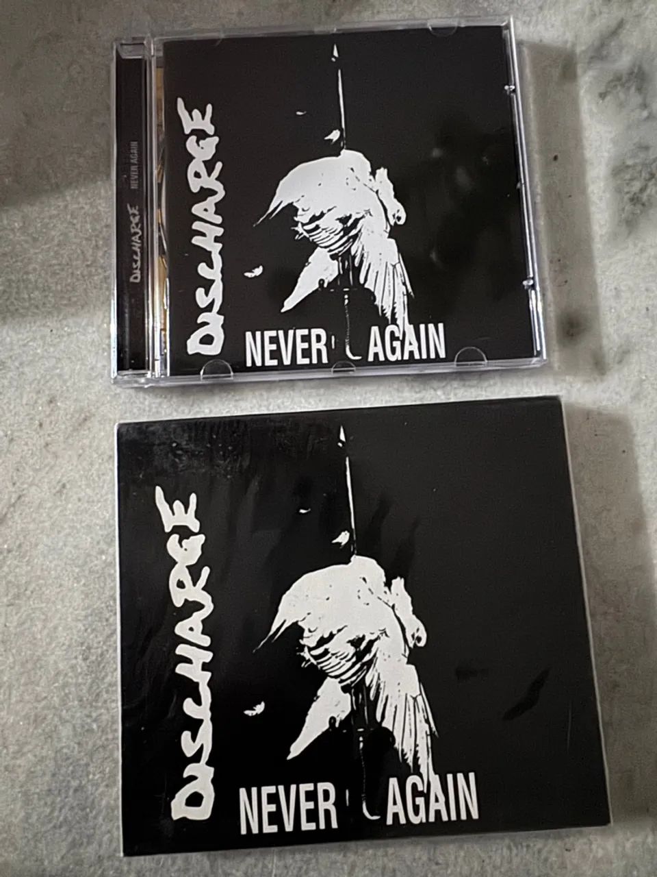 DISCHARGE - NEVER AGAIN - NOVO