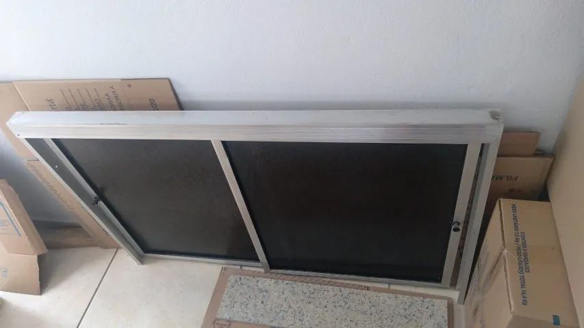 Porta de correr 2 folhas em plástico fumê e alumínio.