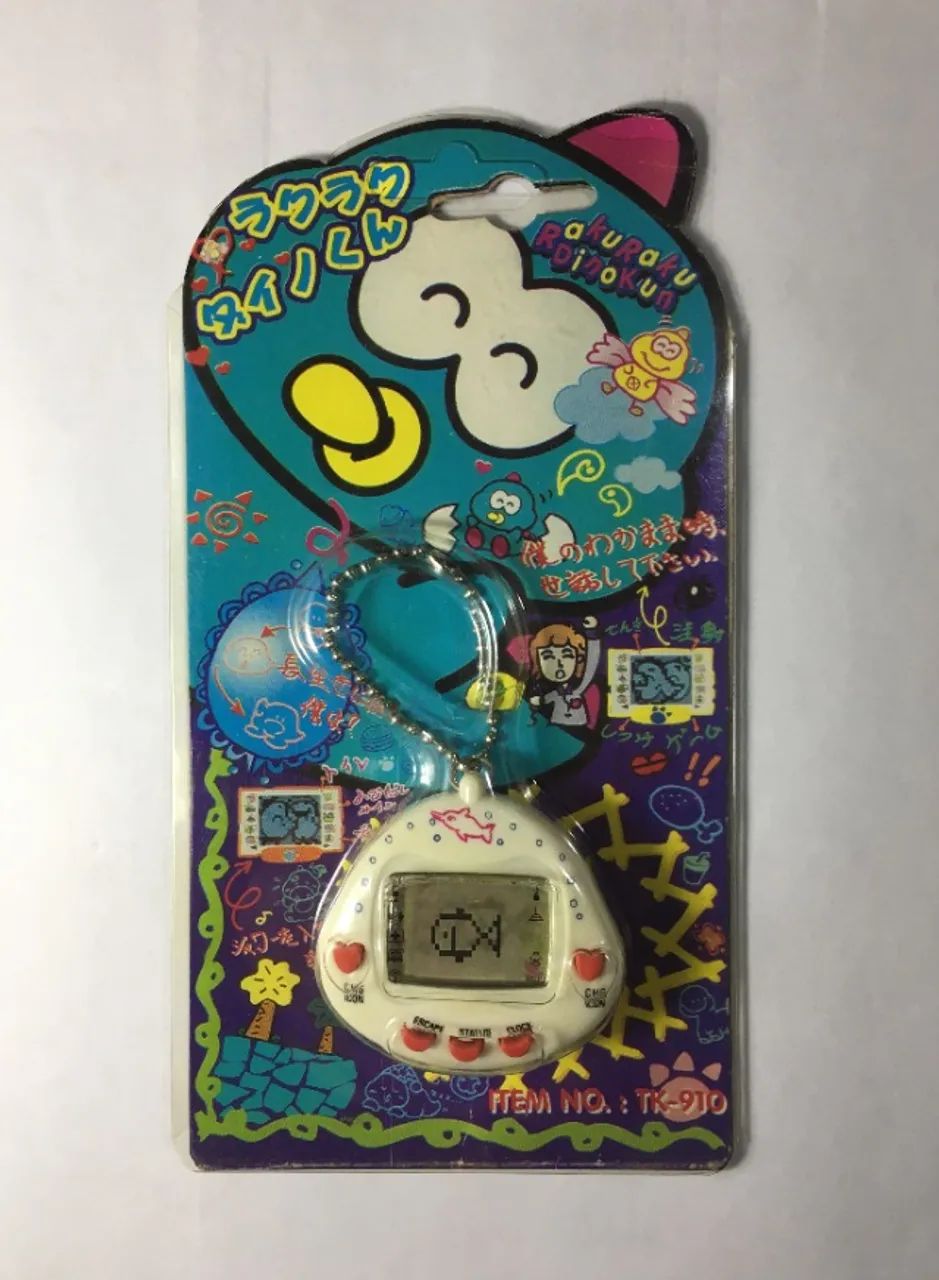 Bichinho Virtual RakuRaku Dinokun TK-910 Branco (Tamagotchi) Anos