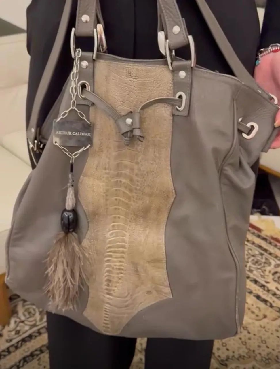 Bolsa Arthur Caliman na cor cinza . Estilosa . Com couro de cobra e pluma de adornos . 