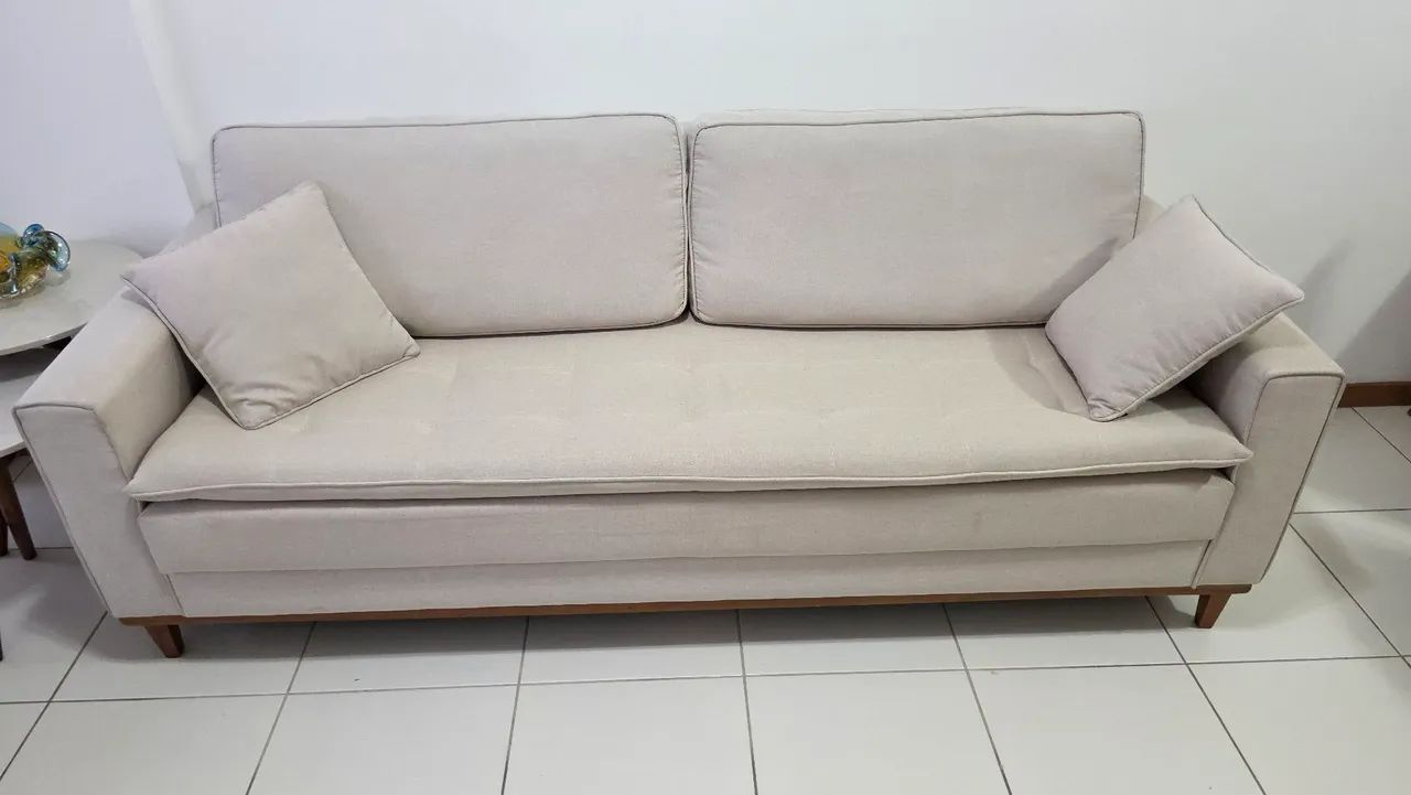Vendo lindo sofá de 3 lugares, na cor bege/off-white, com design elegante e atemporal.