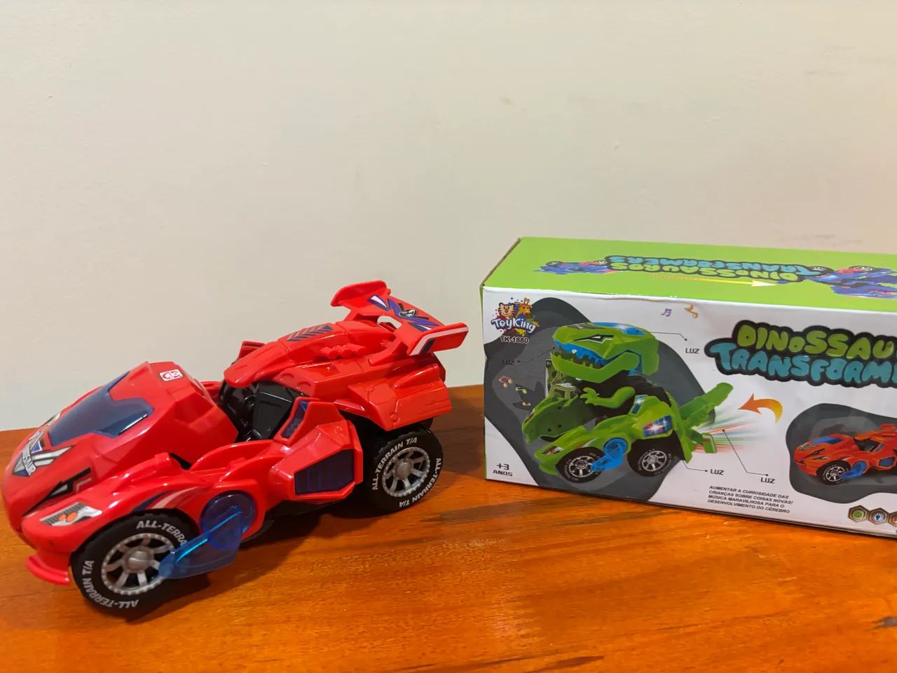 Carrinho Transformers Dinossauro Bate E Volta Sons NOVO