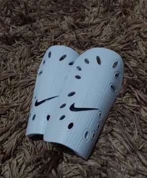 Caneleira Nike 