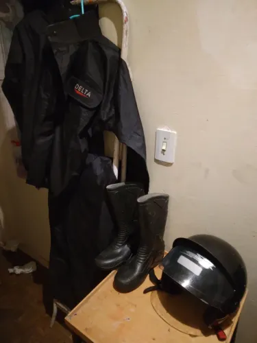 Roupa chuva de motoqueiro com bota e capacete. 