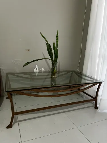 Mesa de centro com tampo de vidro e estrutura metálica