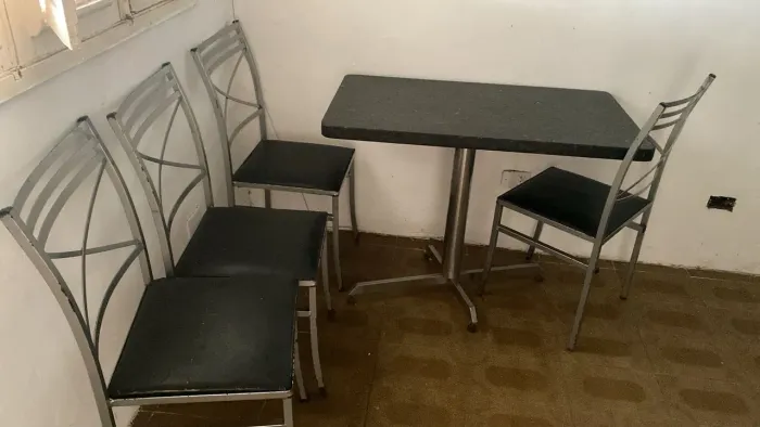 Mesa retangular com tampo de granito e estrutura metálica
