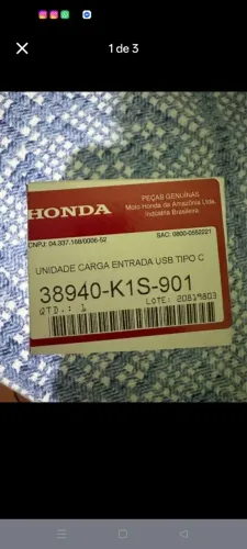 Carregador USB original da Titan 160 2026