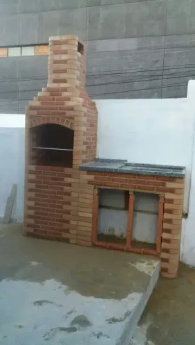Churrasqueira bancada e pia tijolo vermelho com a ponta clara 