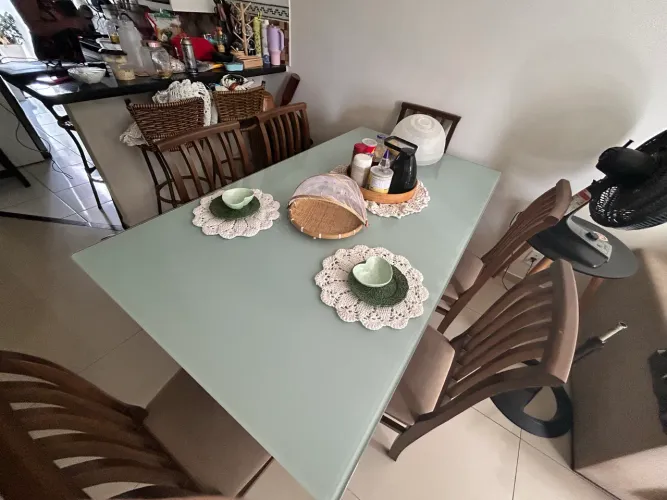 Mesa de vidro envelopada com cadeiras