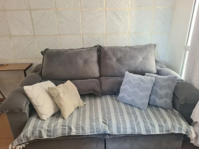 Sofá, rack e armário com mesa imbutida.