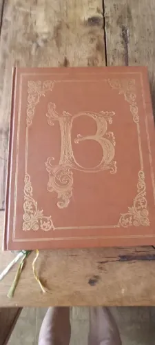 Livro antigo encadernado com letra B em dourado