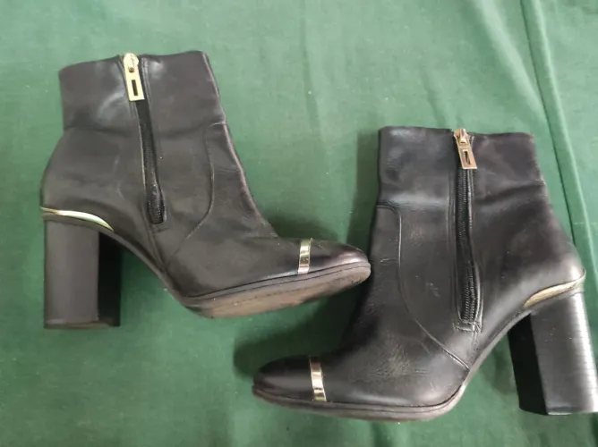 Botas de couro pretas com detalhes dourados