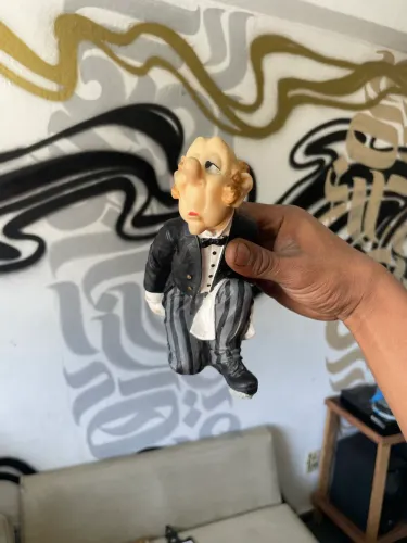 Esta estatueta é um porta-garrafa de vinho