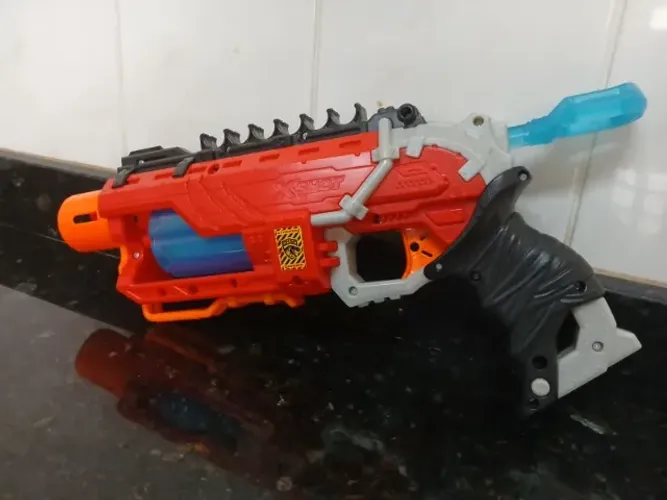 Arma lança dardo X-Shot dinossauro