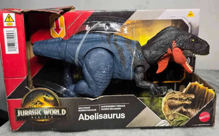 Jurassic World Rebirth Abelisaurus Mattel lacrado<br>Abelisaurus<br>REBIRTH<br>MATTEL