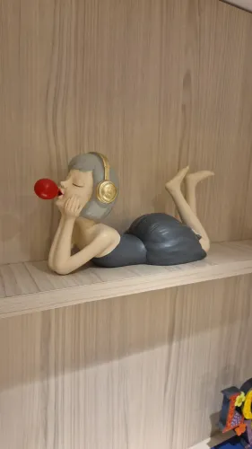 Linda escultura de menina com fones de ouvido