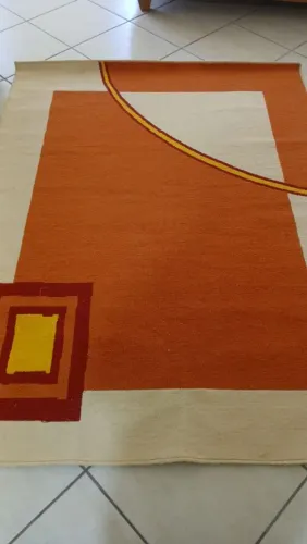 Tapete de lã com design geométrico em terracota , bege e amarelo.