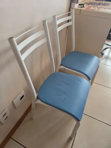 2 cadeiras tubulares com estrutura de ferro branca e assento/encosto estofado na cor azul