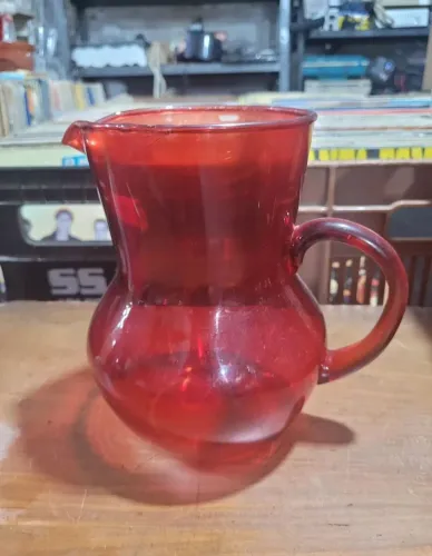 Jarra vintage de vidro vermelho, frequentemente referida como vidro "cranberry" ou rubi.