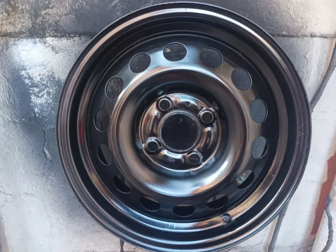 Uma roda aro 15 original da Ford com a calota original junto