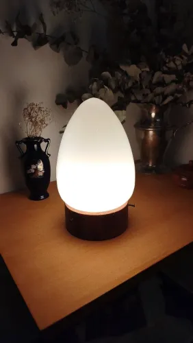 Luminária com base em madeira torneada segmentada, cúpula de opalina no formato oval