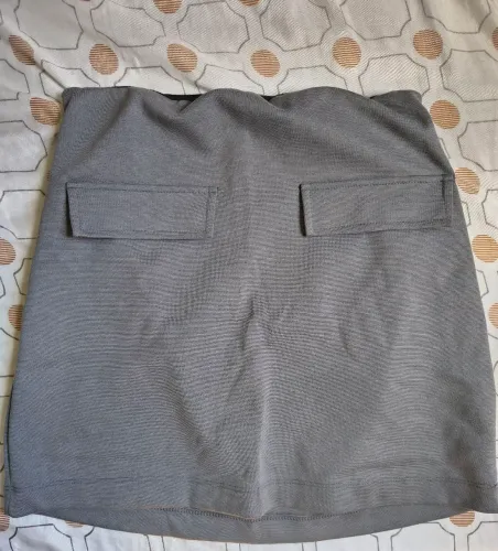 Vendo, saia reta, cor cinza, tamanho P, com elástico na cintura, 20 reais.