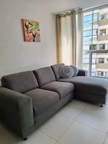 Sofá com três lugares e puff acoplado