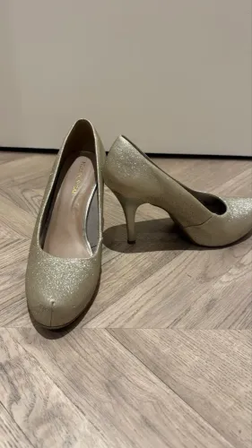 Sapato dourado de salto 