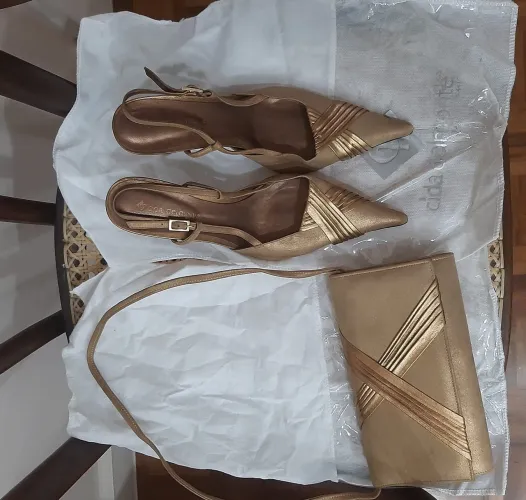 Conjunto clutch e scarpin em suede bege e material dourado
