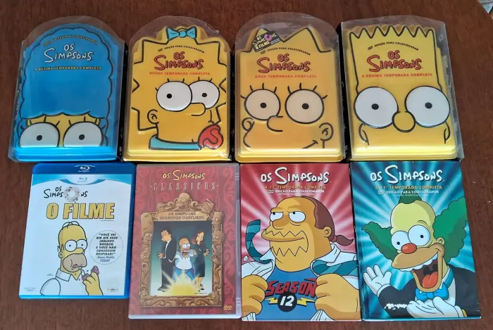 Vendo DVDs de temporadas da Série The Simpsons e um blu-ray do filme The Simpsons.