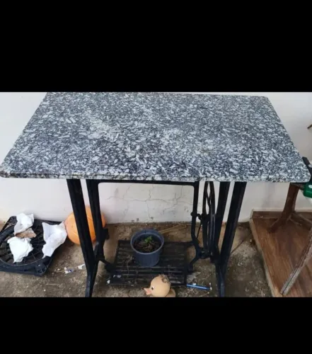 Mesa feita com base de máquina de costura antiga (ferro fundido) com tampo de granito.