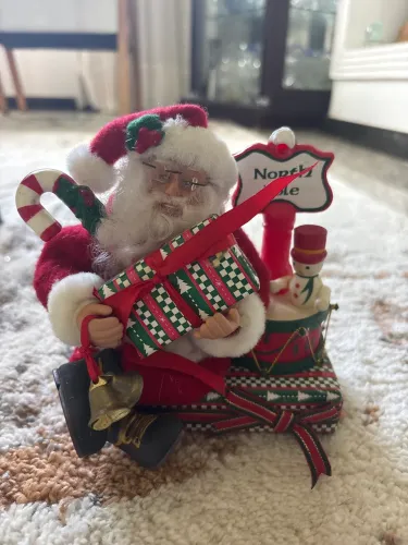 Decoração natalina papai Noel sentado em um presente