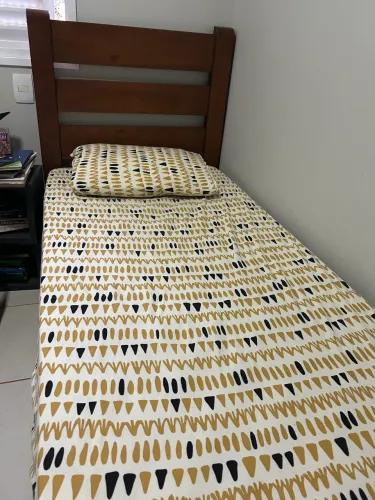 Cama de solteiro em ótimo estado e de madeira maciça.