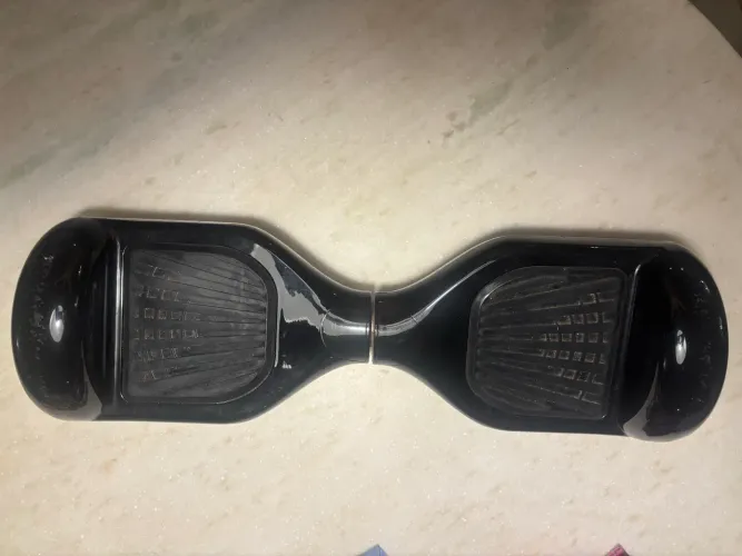 Hoverboard elétrico, especificamente um modelo preto. 