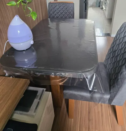 Mesa retangular cinza com 4 cadeiras.
