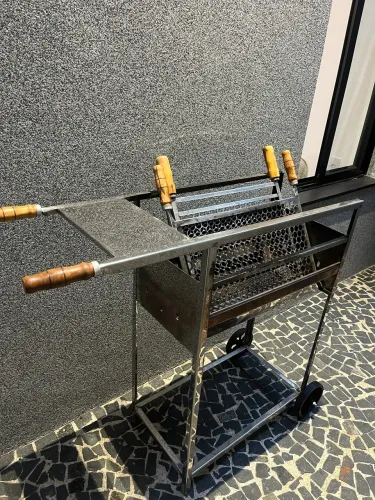 Churrasqueira inox com rodinha e base de apoio mais duas grelhas.