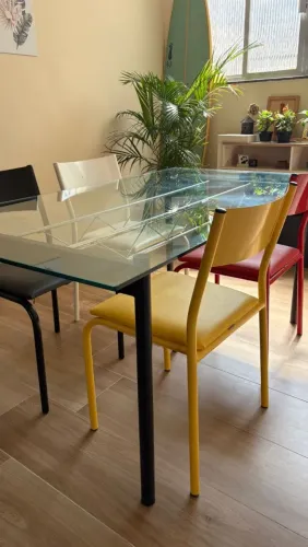 Mesa de vidro e metal estilo industrial contemporânea.