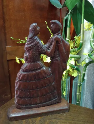 Escultura de casal dançando em madeira