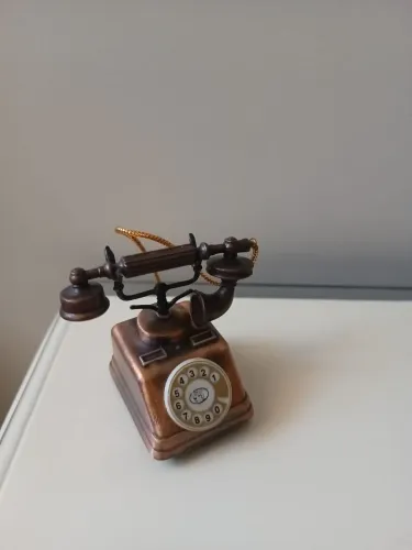 Miniatura de ferro telefone antigo apontador