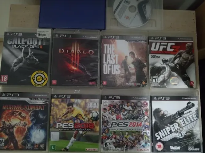 9 jogos, COD2, Diabo3, UFC3, Gran Turismo5, The Leste Of Us, Snipe Elite, pes 14 e 18, MK9