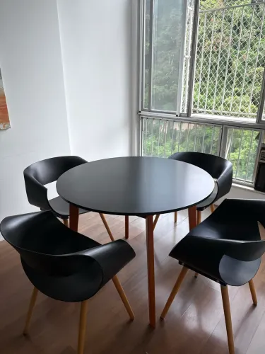 Mesa redonda preta com quatro cadeiras
