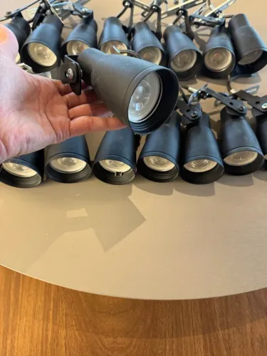 spots pretos para trilho eletrificado equipados com lâmpadas LED.