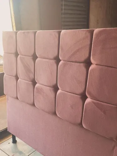 Linda cabeceira de cama estofada na cor rosa, com design moderno e elegante.