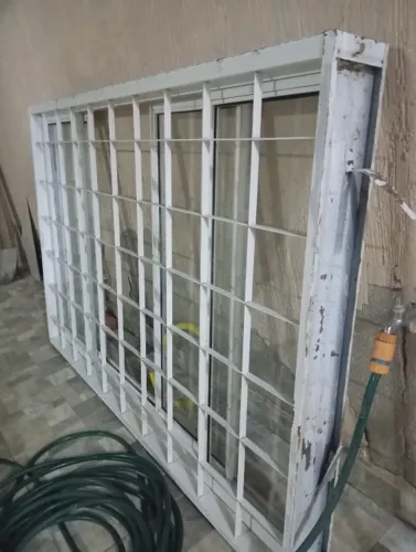 Janela de cozinha com vidros e grade